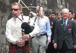 Piper Mal Turner leads the march to the memorial along the old Taipei Prison Wall